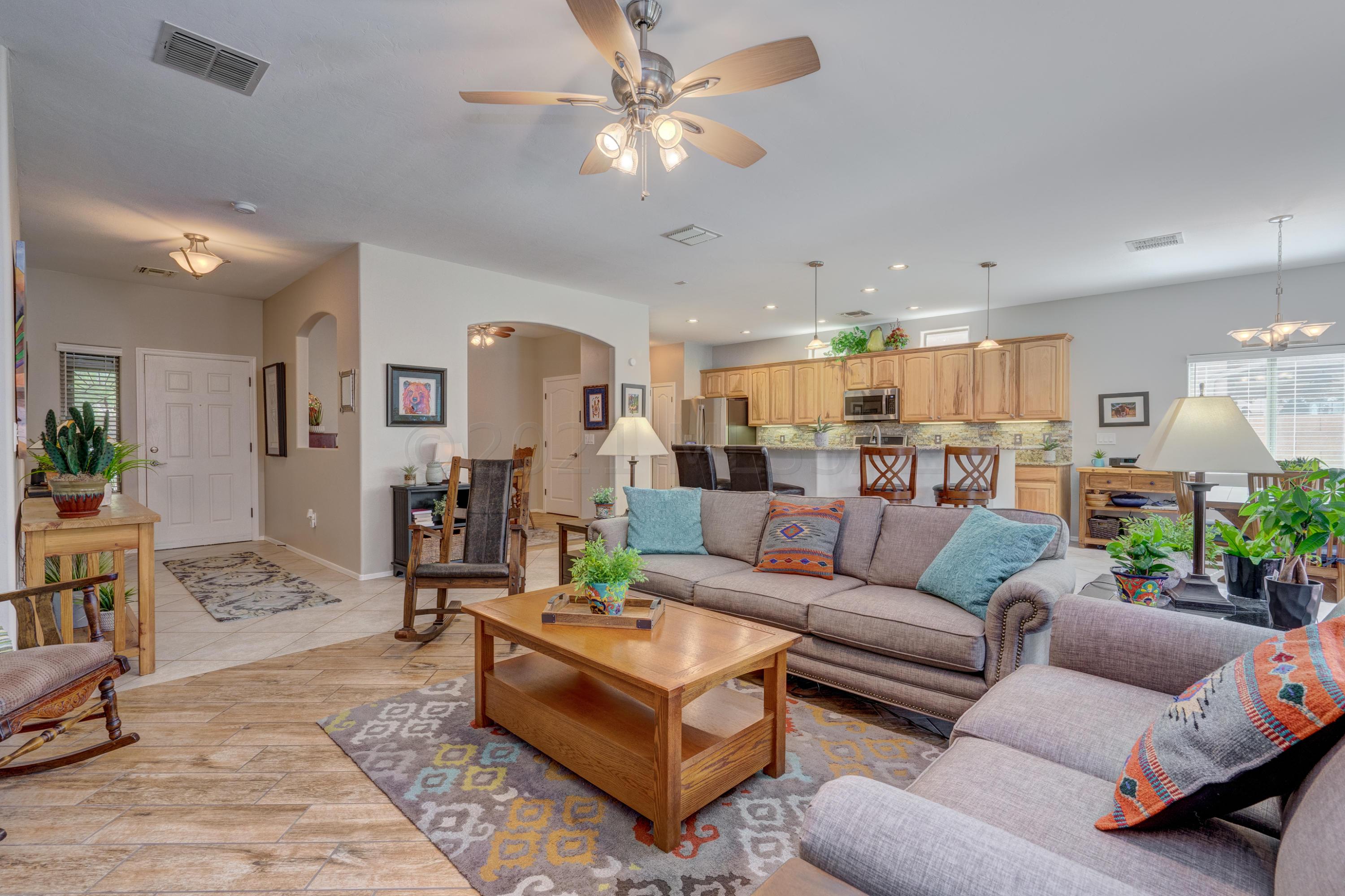3639 East Northern Dancer Road Tucson, AZ 85739 - Photo 5 of 48 a living room with furniture kitchen view and a chandelier
