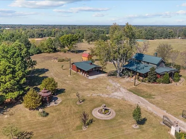 an aerial view of a house with a yard