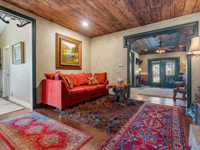 a living room with furniture a rug and a window
