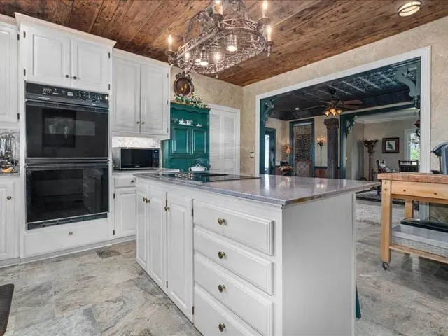 a kitchen with stainless steel appliances granite countertop a stove cabinets and microwave