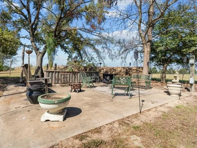 a swimming pool with outdoor seating and yard