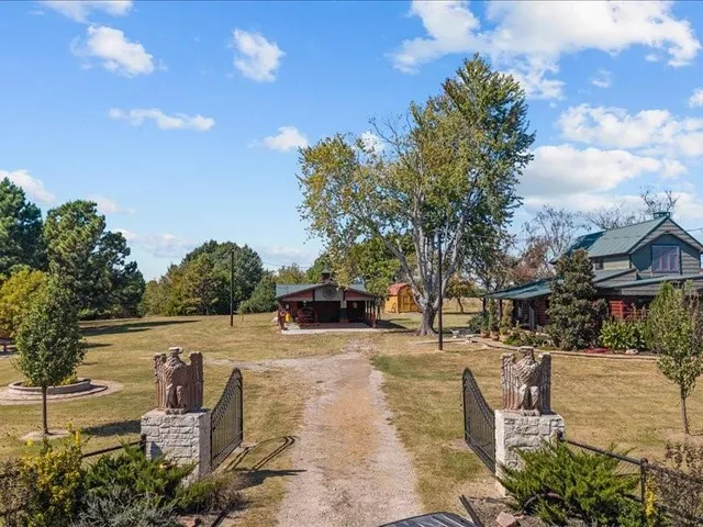 an aerial view of a houses with a yard