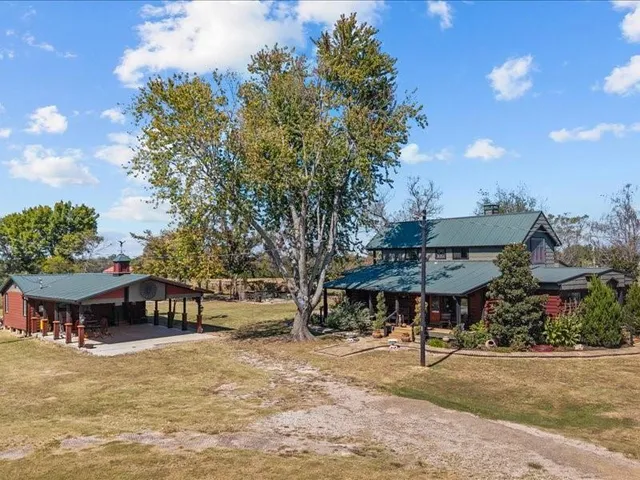 a view of a chairs and table in backyard of the house
