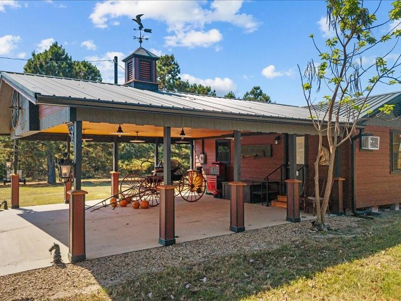 1847 Highway 19 Emory, TX 75440 - Photo 7 of 40 a view of a patio with a table and chairs under an umbrella
