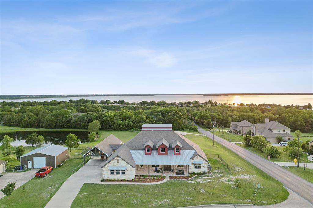 an aerial view of a house with a big yard