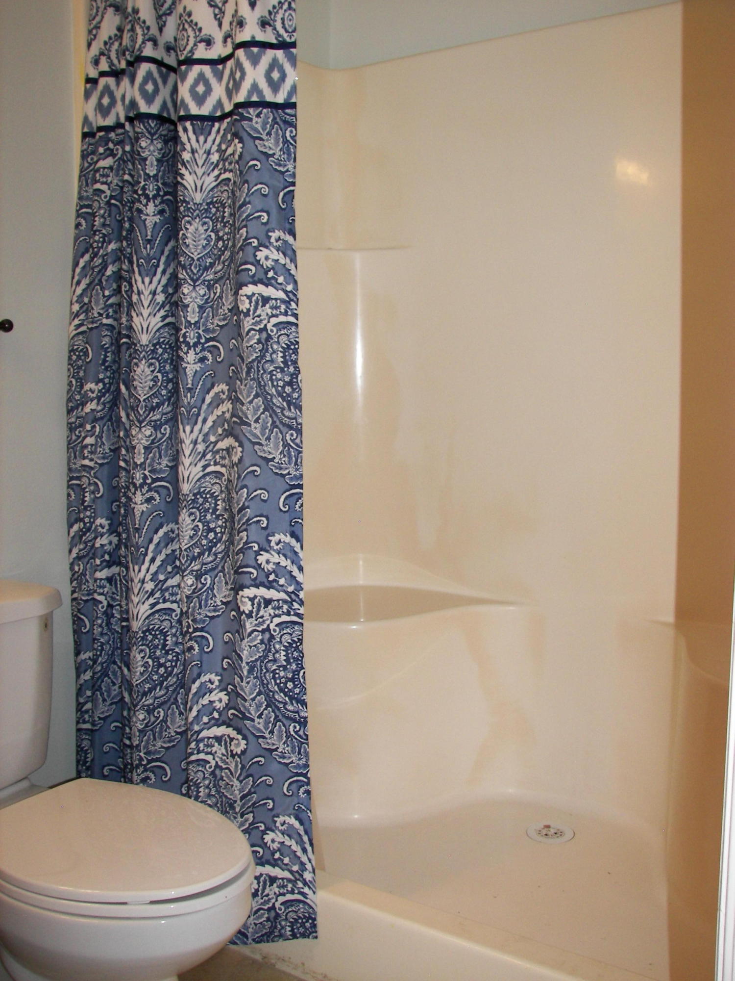 2827 Stoneway Lane, Unit D Fort Pierce, FL 34982 - Photo 11 of 25 a bathroom with a toilet and a shower curtain