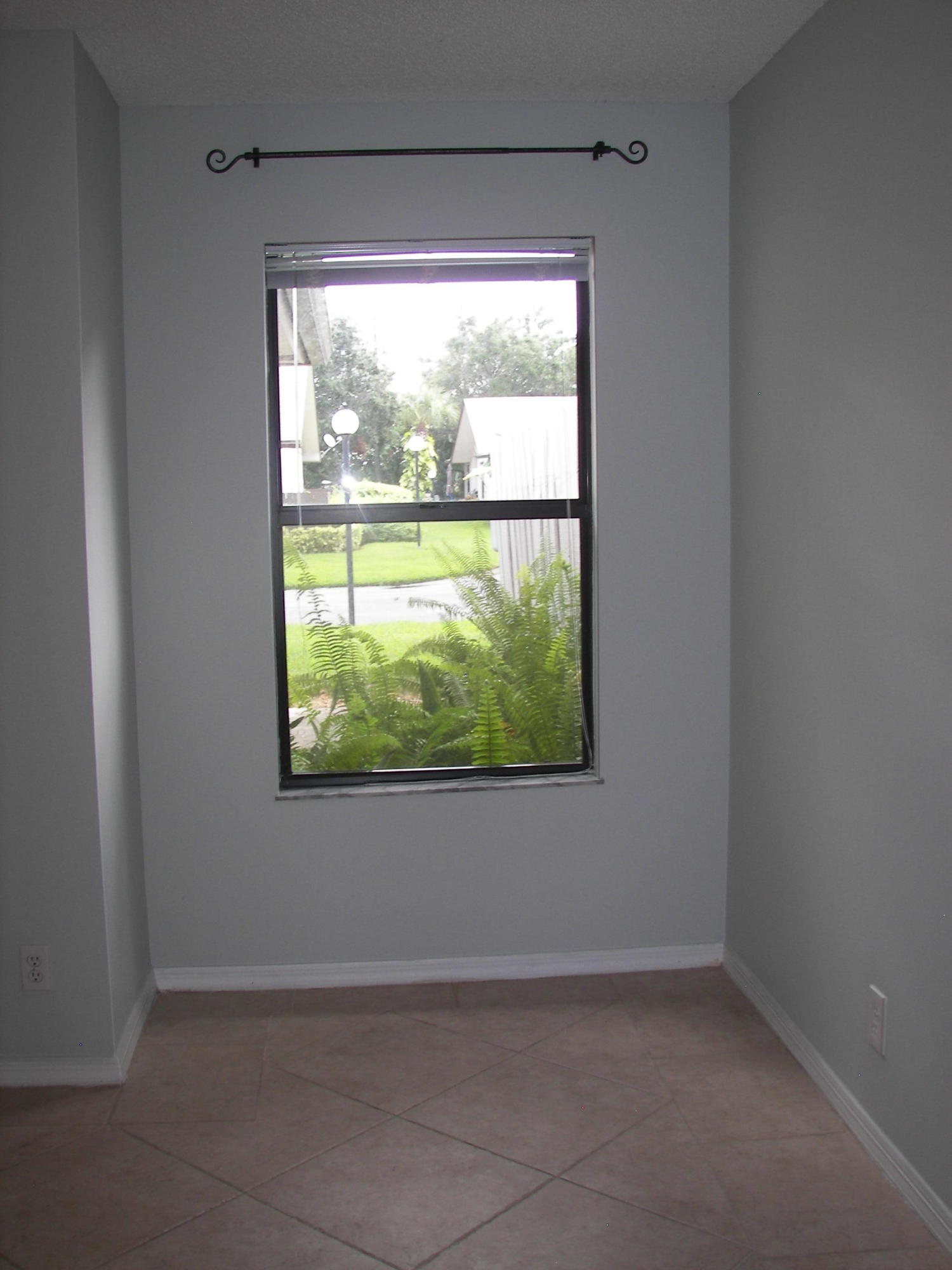 2827 Stoneway Lane, Unit D Fort Pierce, FL 34982 - Photo 16 of 25 a view of an empty room with a window