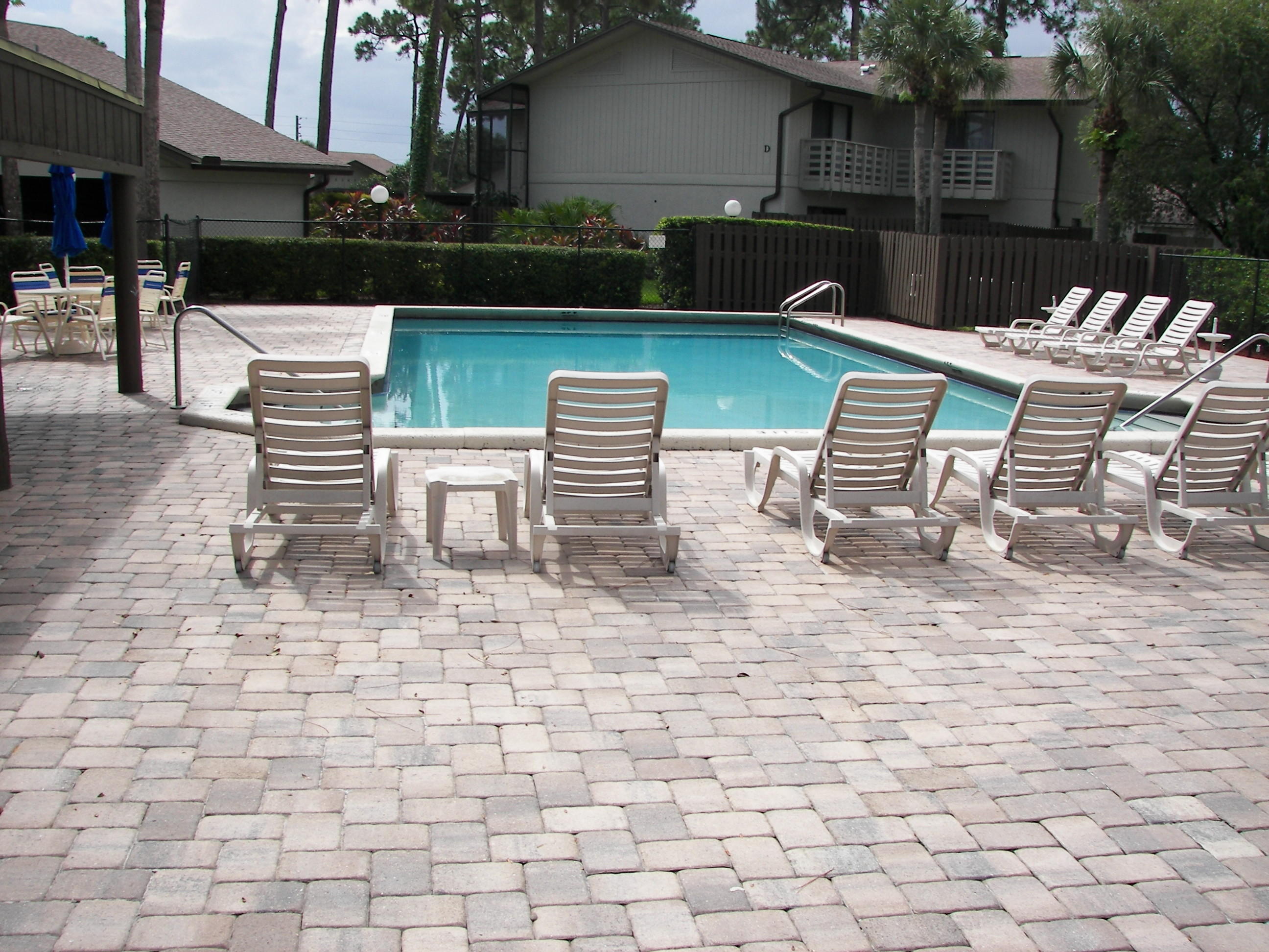 2827 Stoneway Lane, Unit D Fort Pierce, FL 34982 - Photo 21 of 25 a view of a chairs and table in backyard