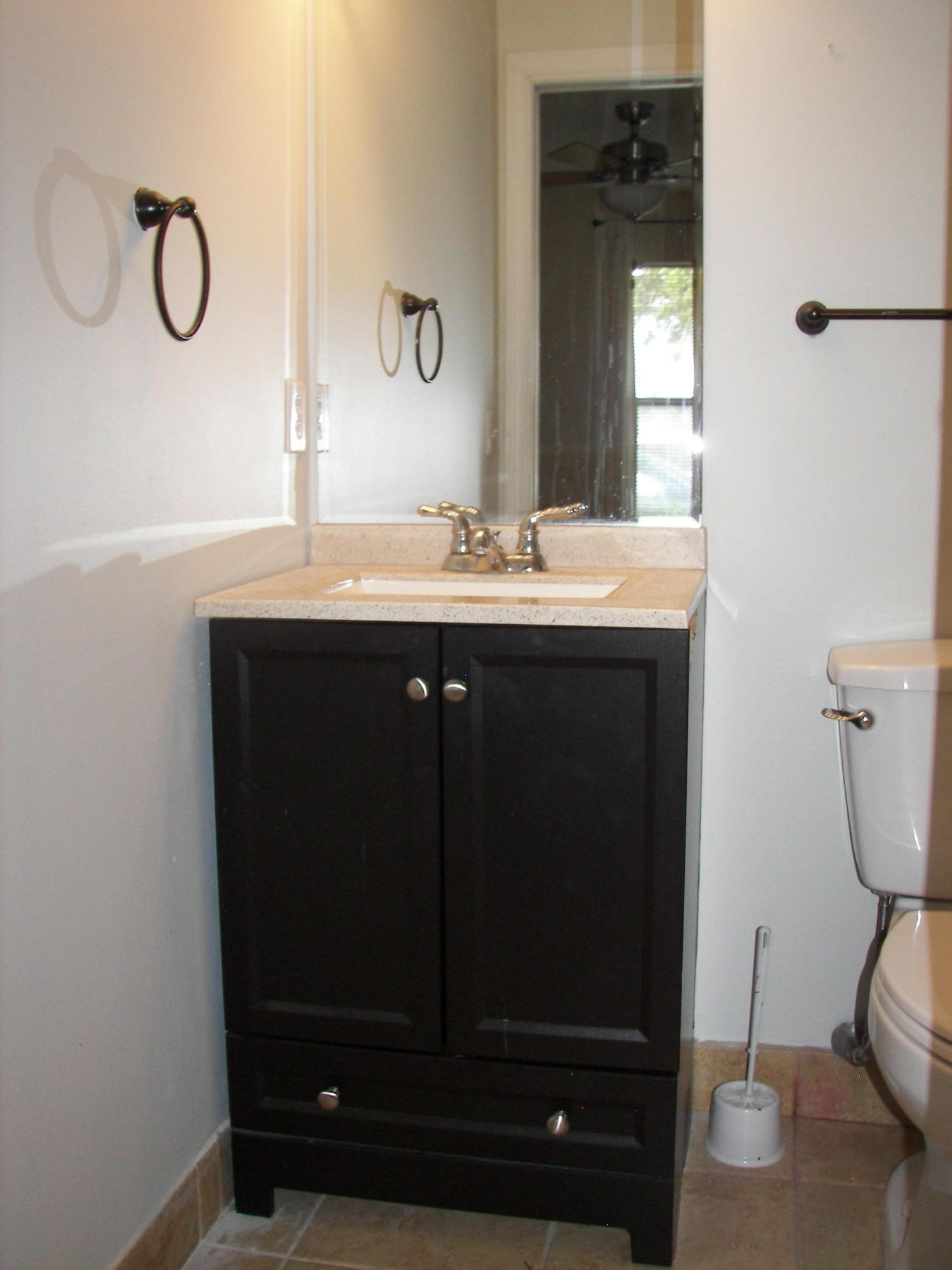2827 Stoneway Lane, Unit D Fort Pierce, FL 34982 - Photo 10 of 25 a bathroom with a sink and a mirror