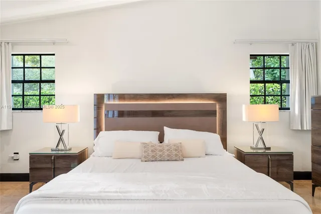 a bedroom with a bed and a lamp on table