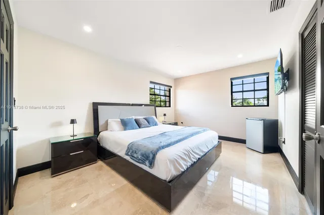 a large bedroom with bed and a dresser