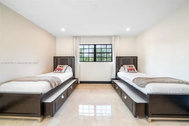 a spacious bedroom with a bed and window