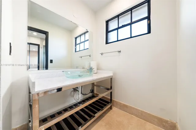a kitchen with stainless steel appliances kitchen island sink stove and refrigerator