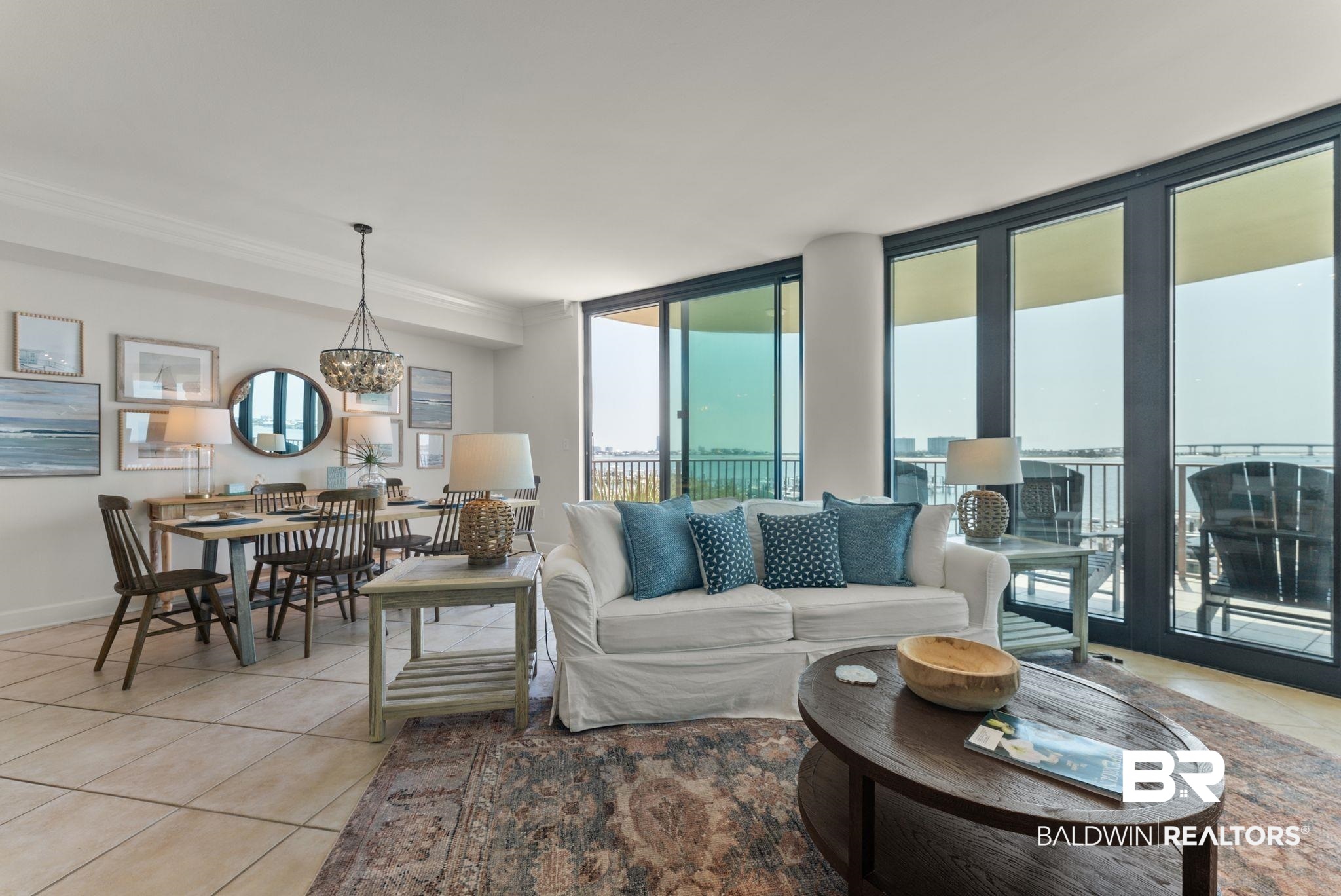 27580 Canal Road, Unit 1233 Orange Beach, AL 36561 - Photo 47 of 79 Living area featuring light tile patterned floors, suspended lighting, and ornamental molding