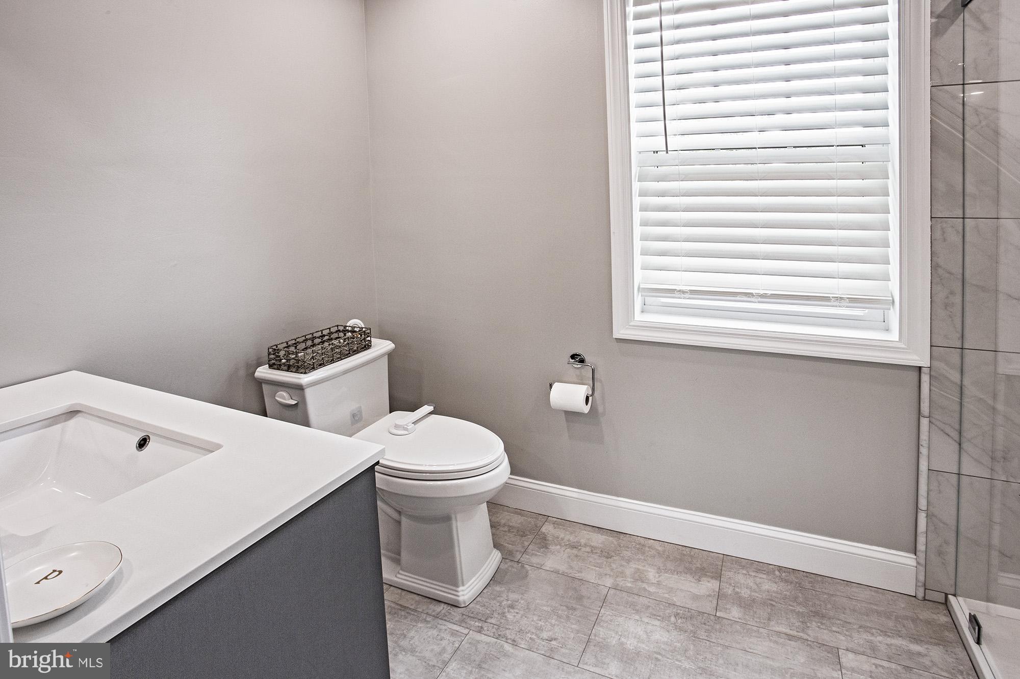 5000 Ogletown Stanton Road Newark, DE 19713 - Photo 16 of 39 a white toilet sitting next to a bathroom sink