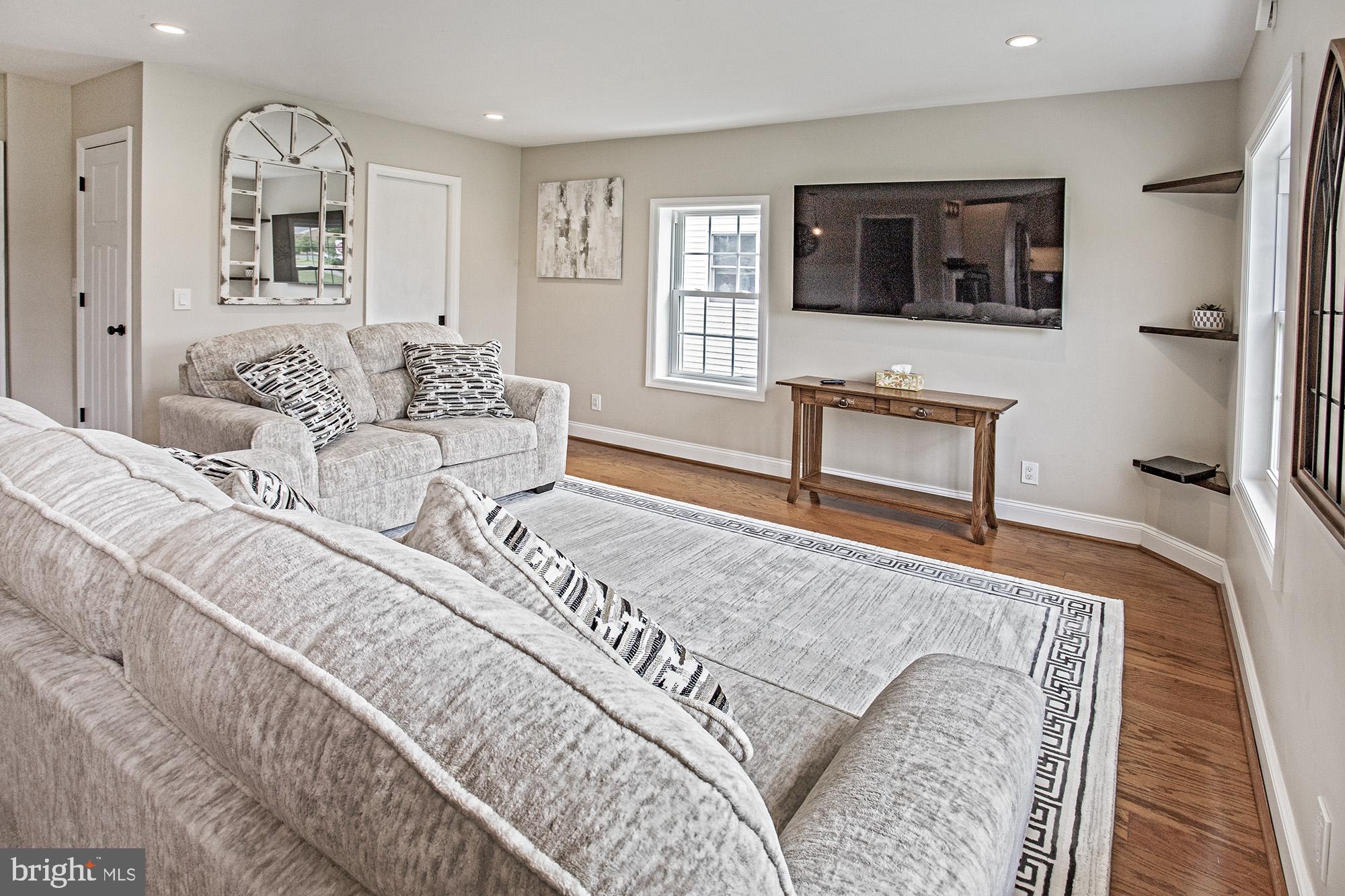 5000 Ogletown Stanton Road Newark, DE 19713 - Photo 4 of 39 a living room with a couch and a flat screen tv