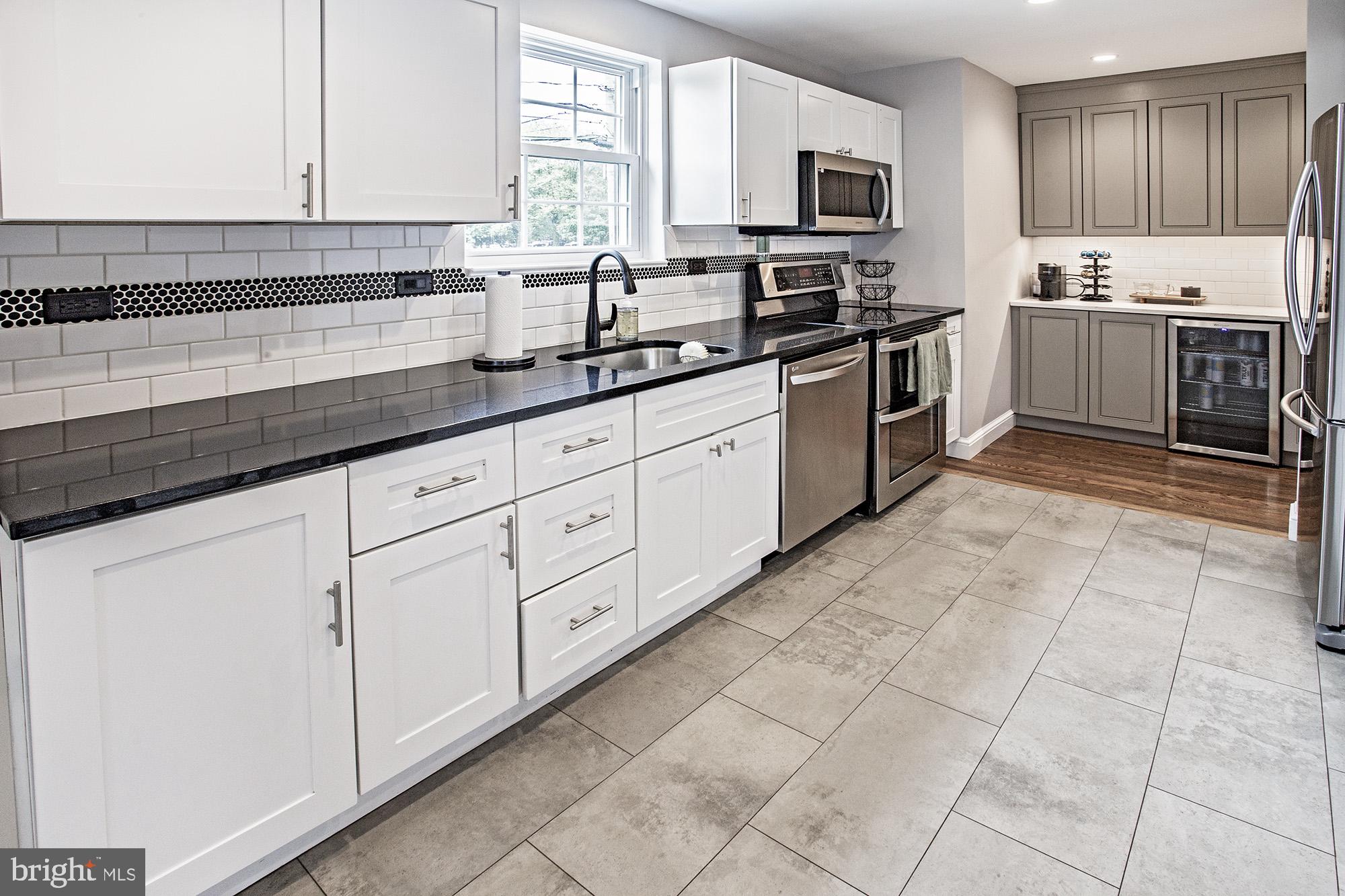 5000 Ogletown Stanton Road Newark, DE 19713 - Photo 7 of 39 a kitchen with stainless steel appliances granite countertop a sink a stove and cabinets