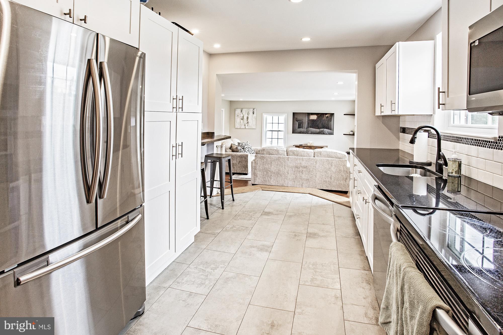 5000 Ogletown Stanton Road Newark, DE 19713 - Photo 9 of 39 a kitchen with stainless steel appliances granite countertop a refrigerator and a stove top oven