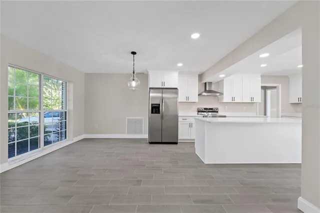 a view of kitchen with stainless steel appliances refrigerator oven and cabinets