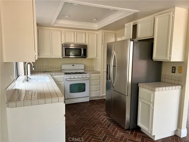 a kitchen with a refrigerator stove and microwave