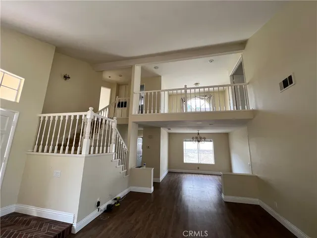 a view of an entryway with wooden floor and windows
