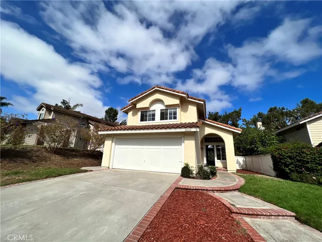 a view of a white house with a yard