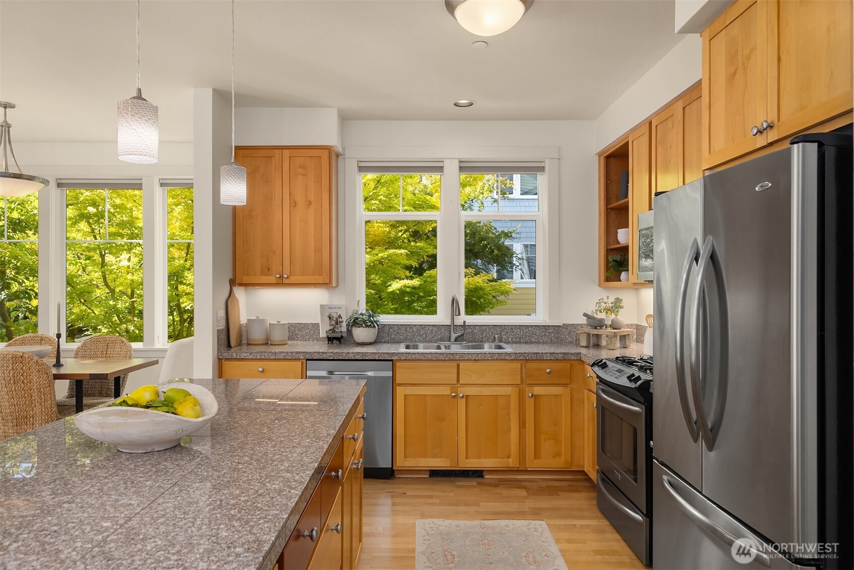 144 Hall Brothers Loop Northwest, Unit 101 Bainbridge Island, WA 98110 - Photo 13 of 30 a kitchen with a window a sink and a refrigerator