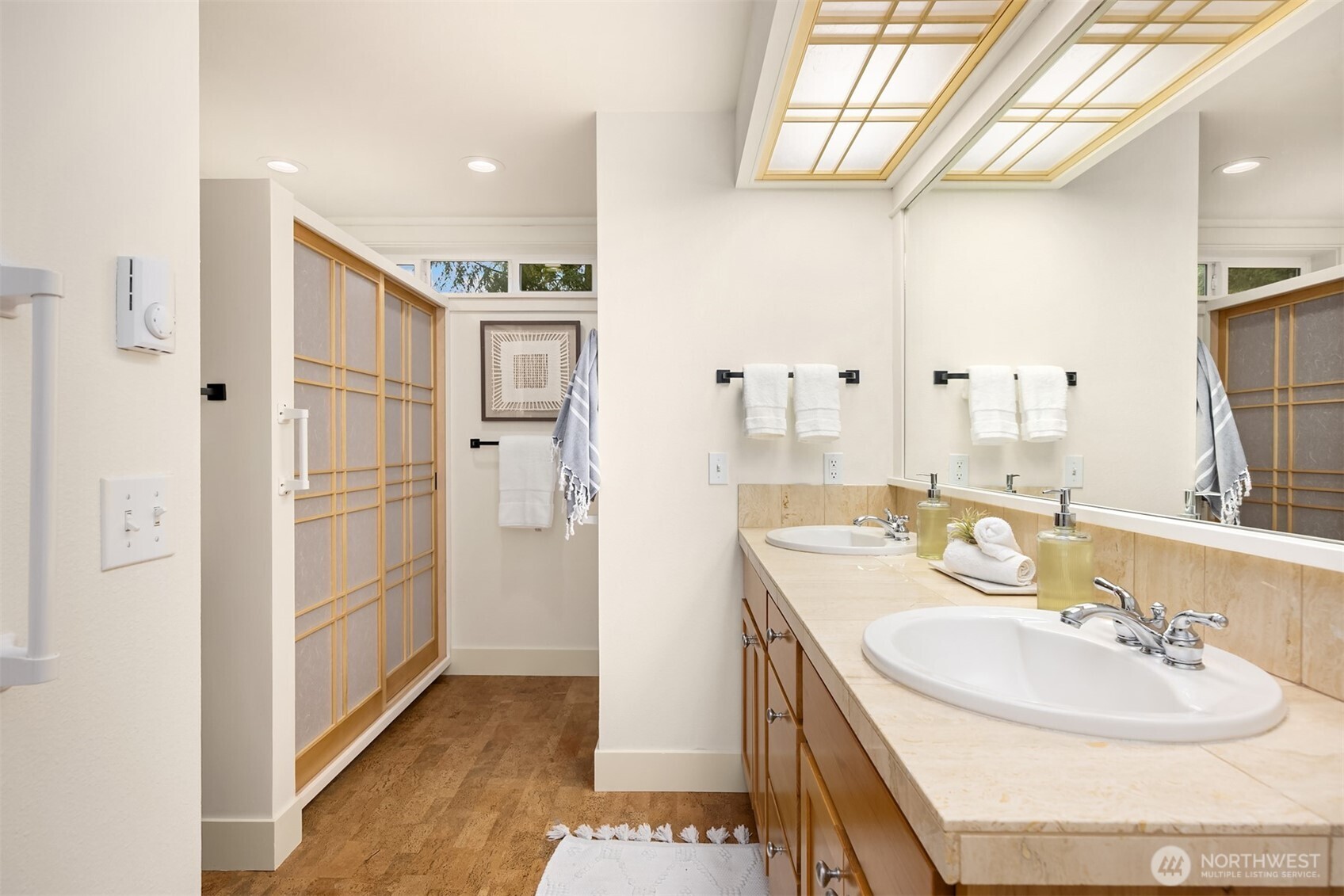 144 Hall Brothers Loop Northwest, Unit 101 Bainbridge Island, WA 98110 - Photo 18 of 30 a bathroom with a sink and a mirror