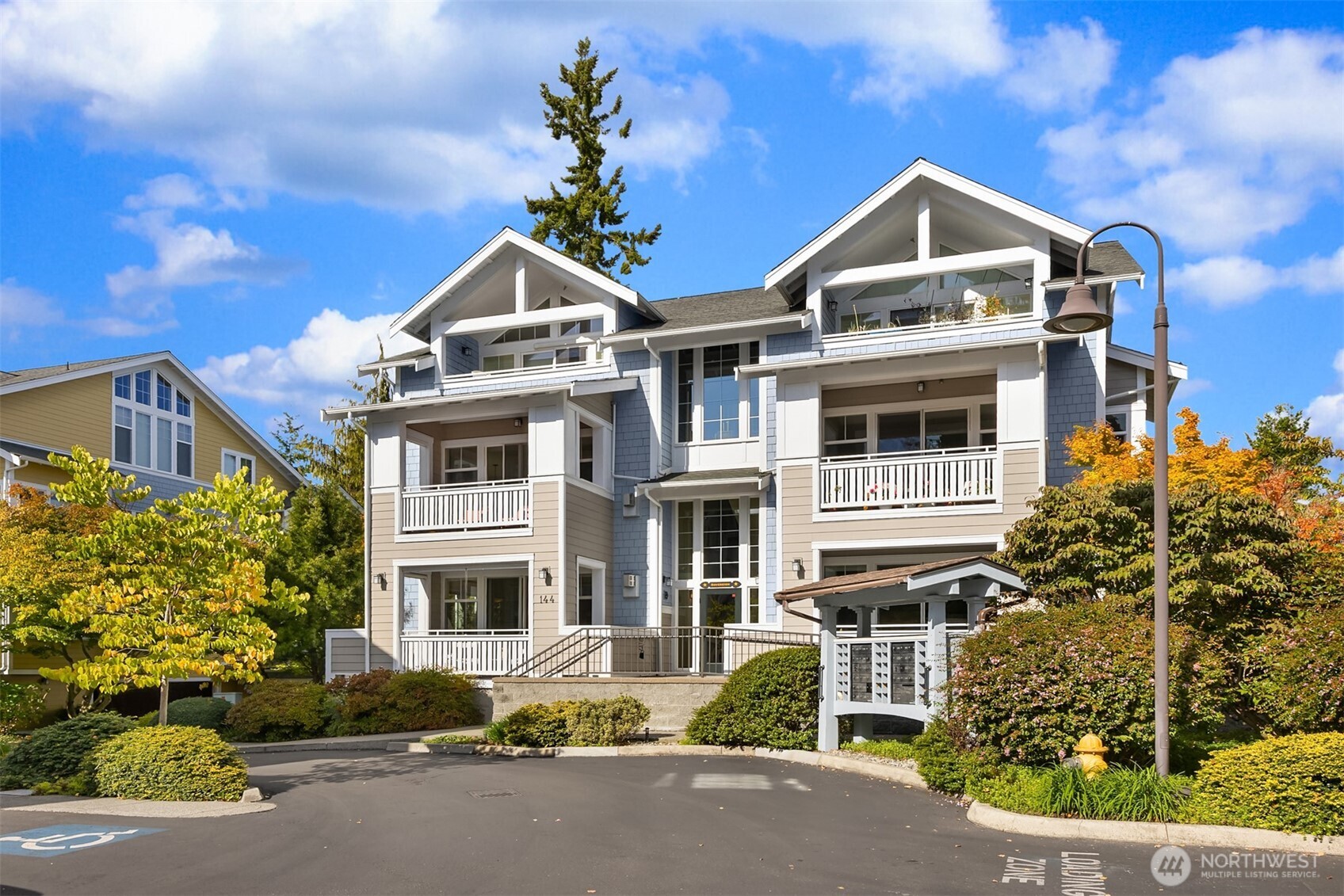 144 Hall Brothers Loop Northwest, Unit 101 Bainbridge Island, WA 98110 - Photo 26 of 28 a front view of a house with a yard