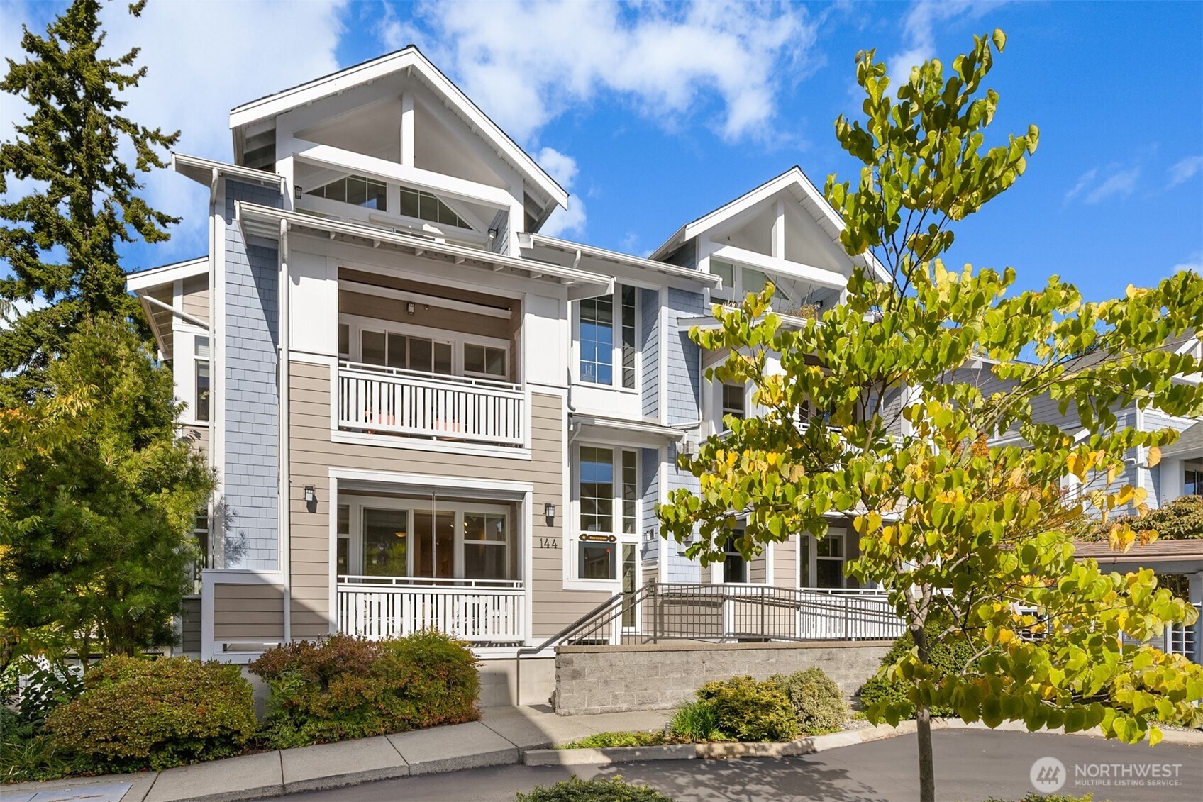 144 Hall Brothers Loop Northwest, Unit 101 Bainbridge Island, WA 98110 - Photo 30 of 30 a front view of a house with a yard