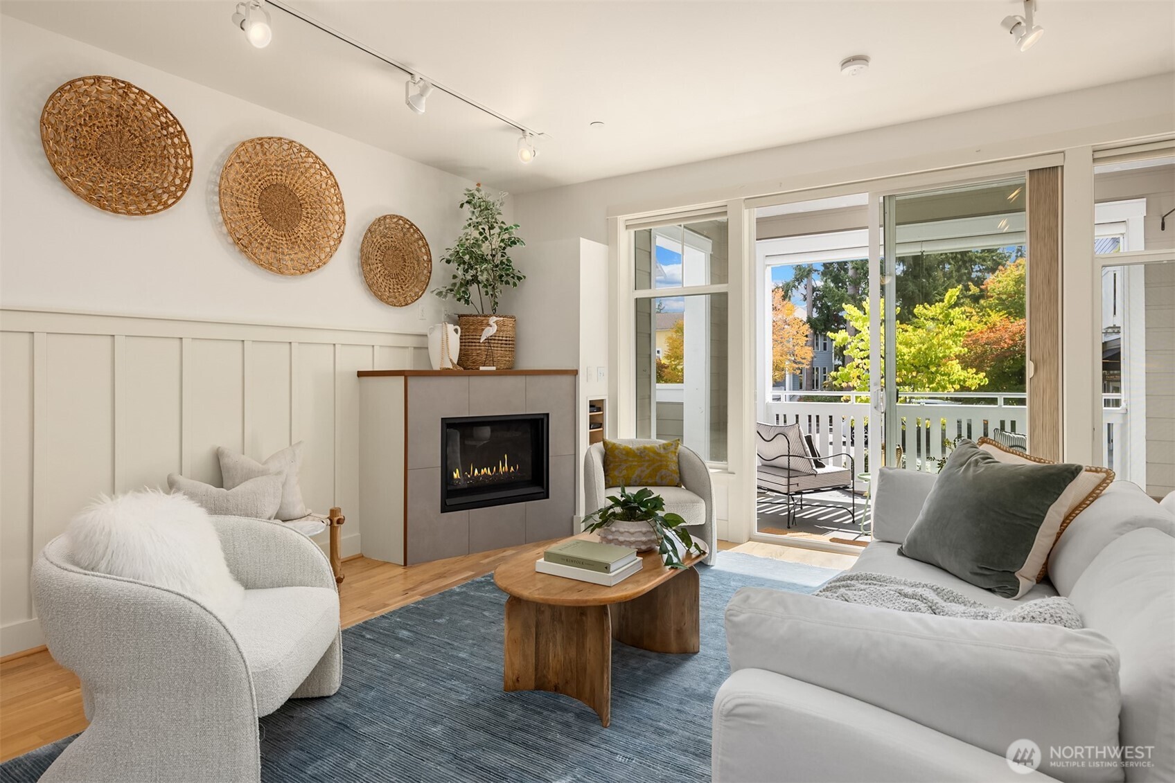 144 Hall Brothers Loop Northwest, Unit 101 Bainbridge Island, WA 98110 - Photo 5 of 28 a living room with furniture and a fireplace