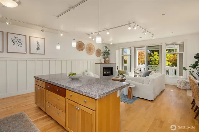 a living room with furniture and a dining table with kitchen view