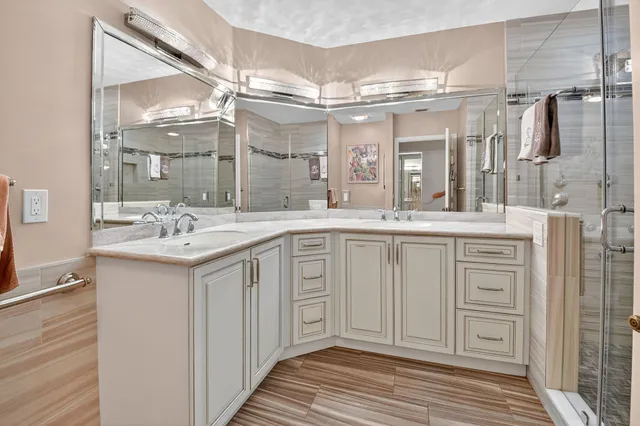 a bathroom with a shower sink and mirror