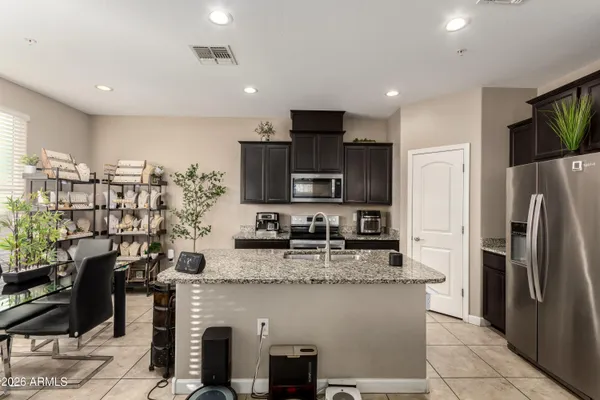 a kitchen with stainless steel appliances granite countertop a refrigerator sink and cabinets