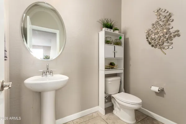 a bathroom with a sink toilet and a mirror