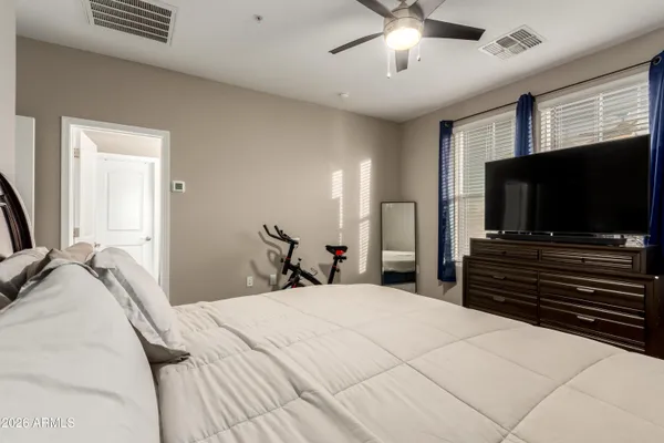 a bedroom with a bed and a flat screen tv