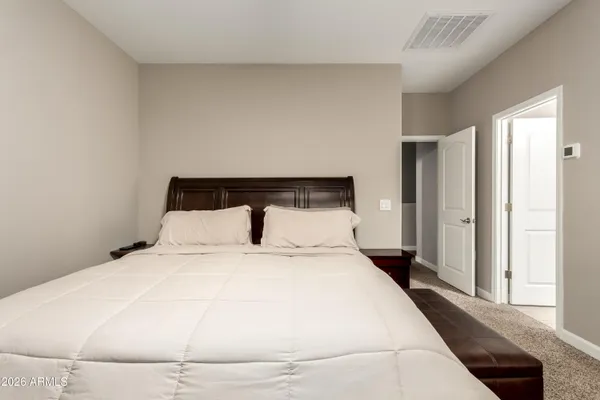 a large white bed in a small room