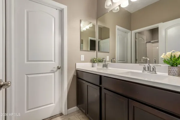 a bathroom with a double vanity sink and a mirror