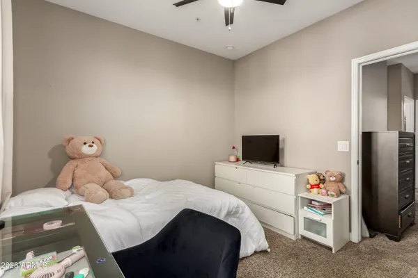 a bedroom with a bed and a tv