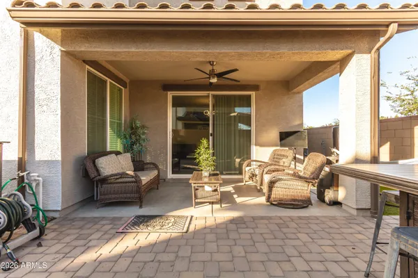 a living room with furniture and floor to ceiling windows