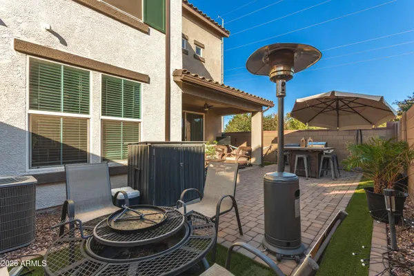 a view of a dining room with furniture a chandelier and wooden floor