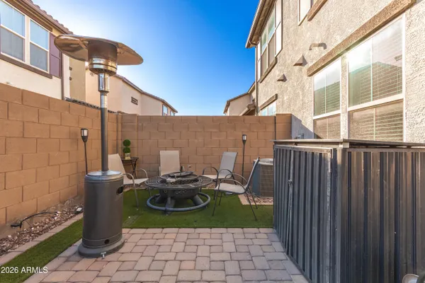 a view of a patio with table and chairs