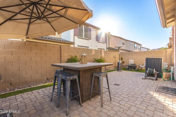 a view of a patio with a table and chairs and potted plants