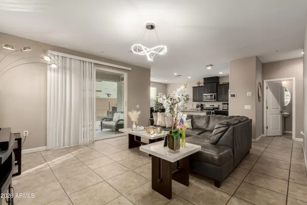 a living room with fireplace furniture and a chandelier
