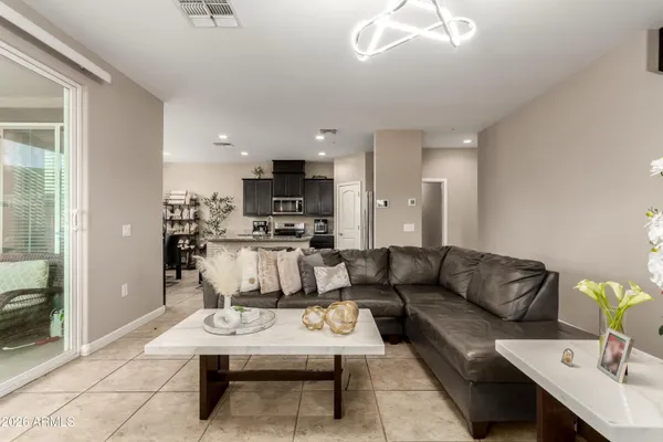a living room with furniture and a view of kitchen