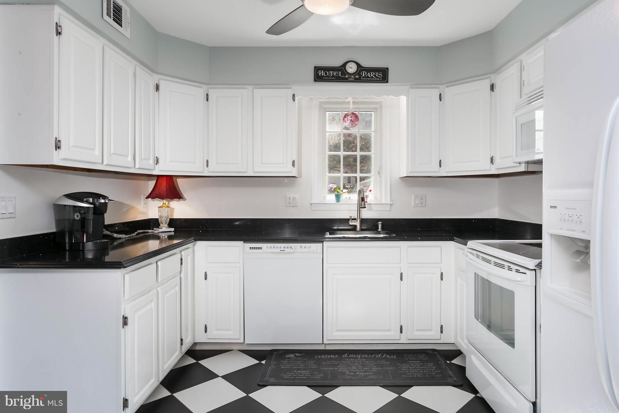 5106 Beaverbrook Road Columbia, MD 21044 - Photo 12 of 30 a kitchen with granite countertop white cabinets and white appliances