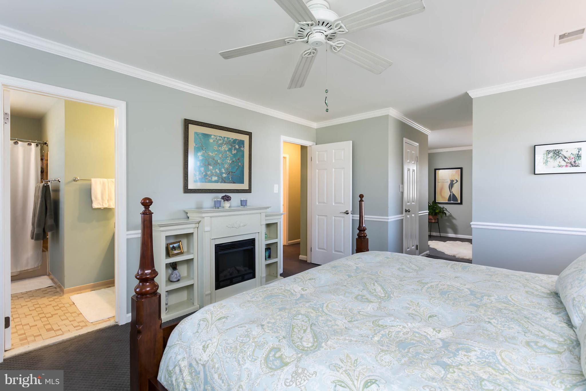 5106 Beaverbrook Road Columbia, MD 21044 - Photo 16 of 30 a bedroom with a large bed and a chandelier
