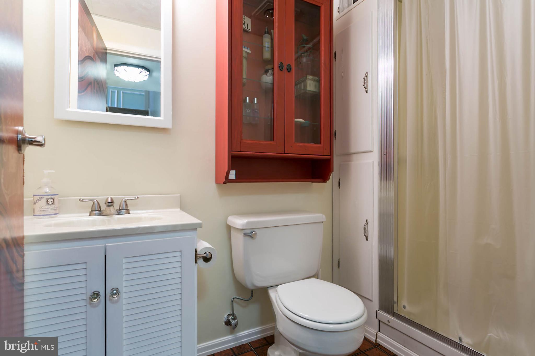 5106 Beaverbrook Road Columbia, MD 21044 - Photo 25 of 30 a bathroom with a toilet a sink and mirror