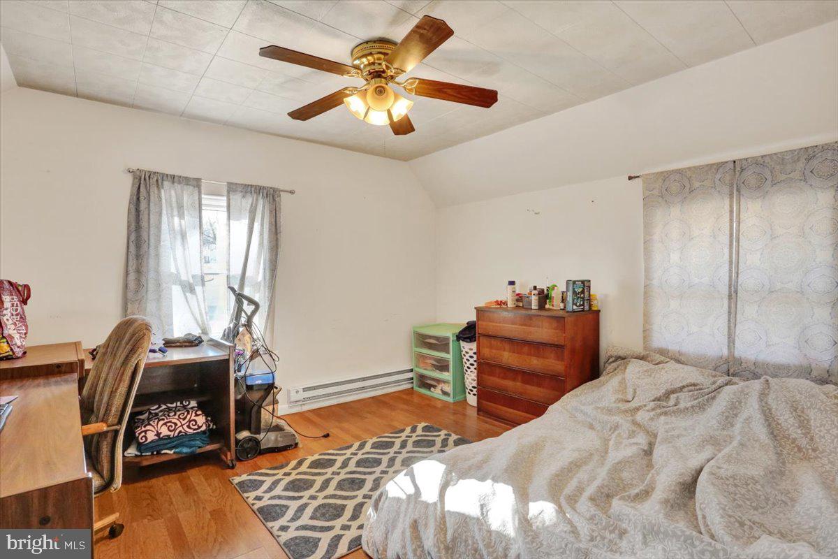321 Pershing Boulevard Reading, PA 19607 - Photo 16 of 36 a bedroom with a bed and a chandelier