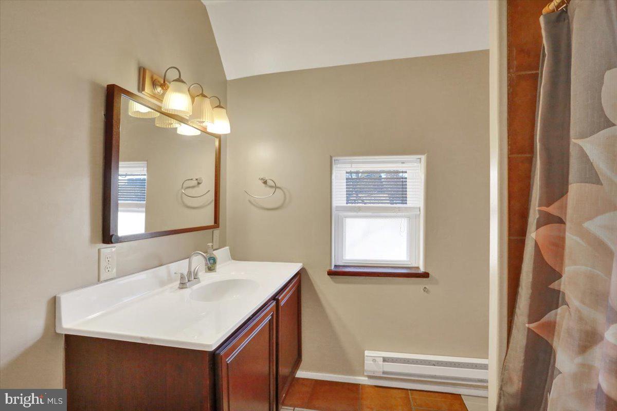 321 Pershing Boulevard Reading, PA 19607 - Photo 18 of 36 a bathroom with a sink a mirror and a window